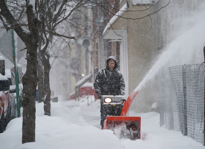 Homem tirando a neve da calçada na Filadélfia